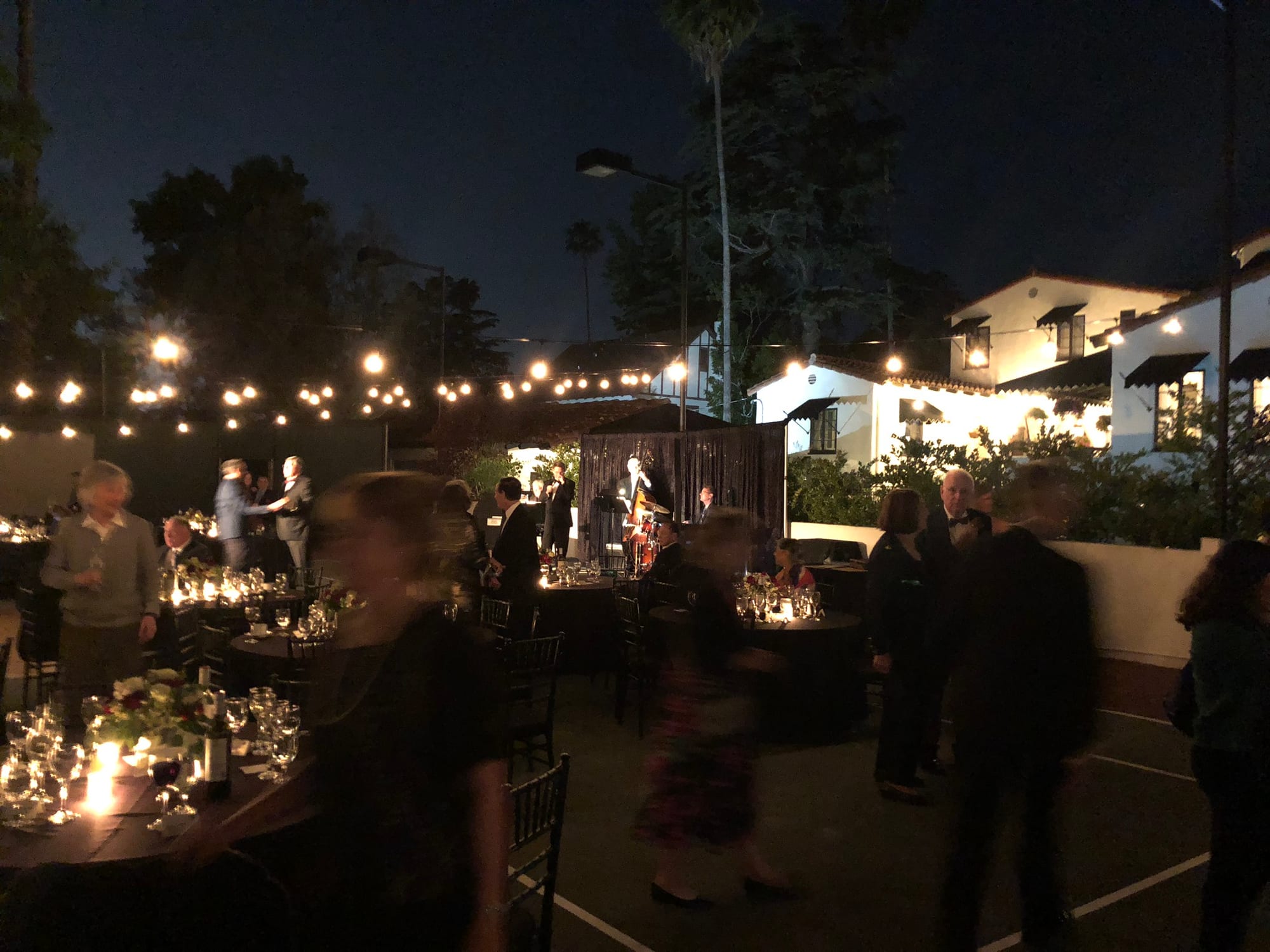 Candlelit dinner tables set across the terrace