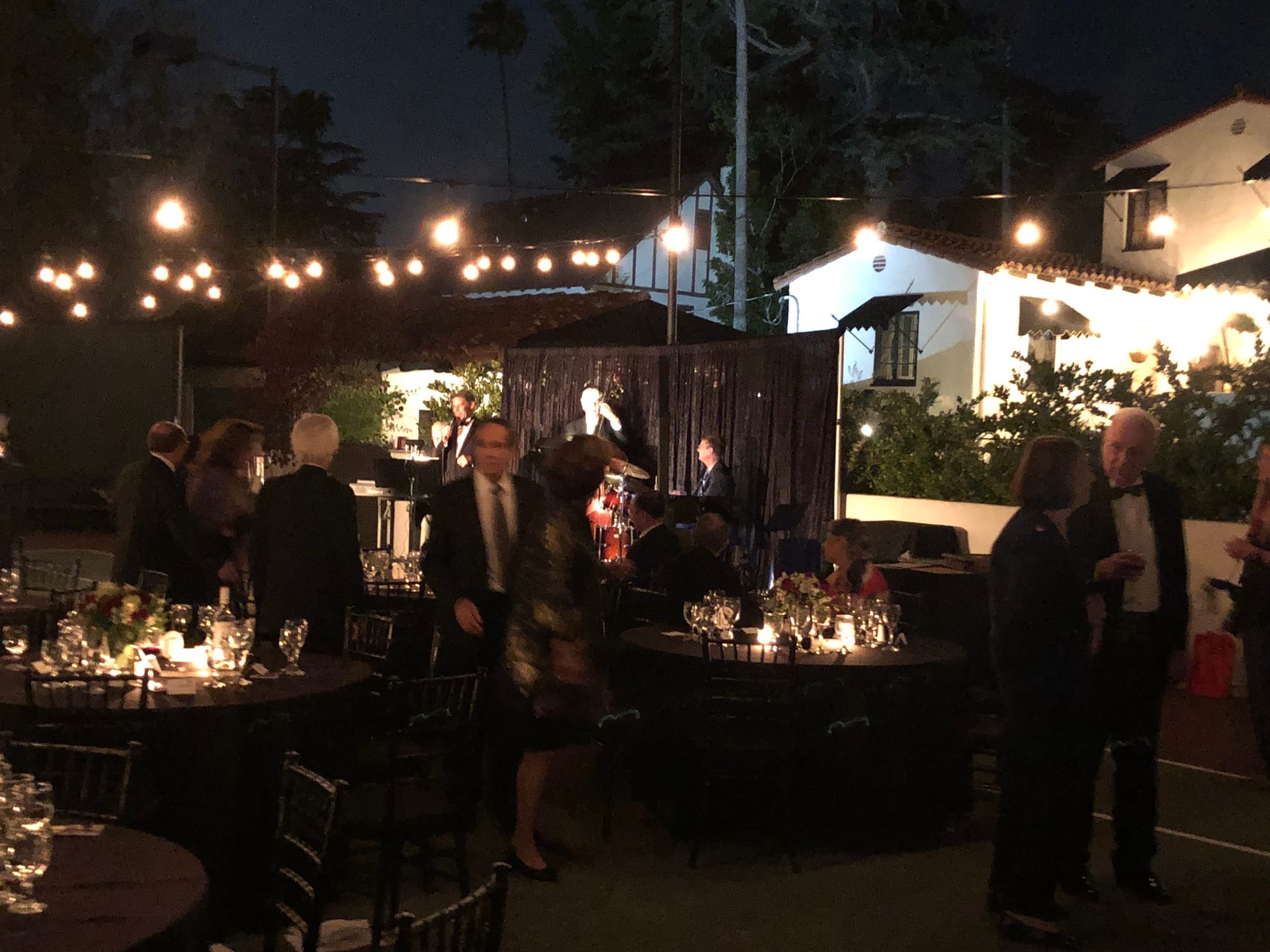 Formal dinner service under warm string lighting