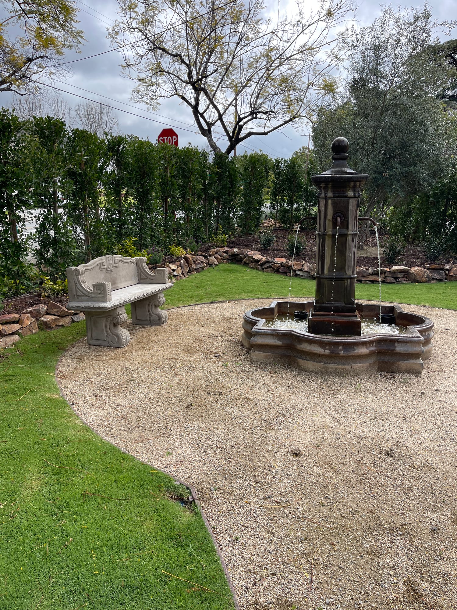 Garden fountain with a carved stone bench