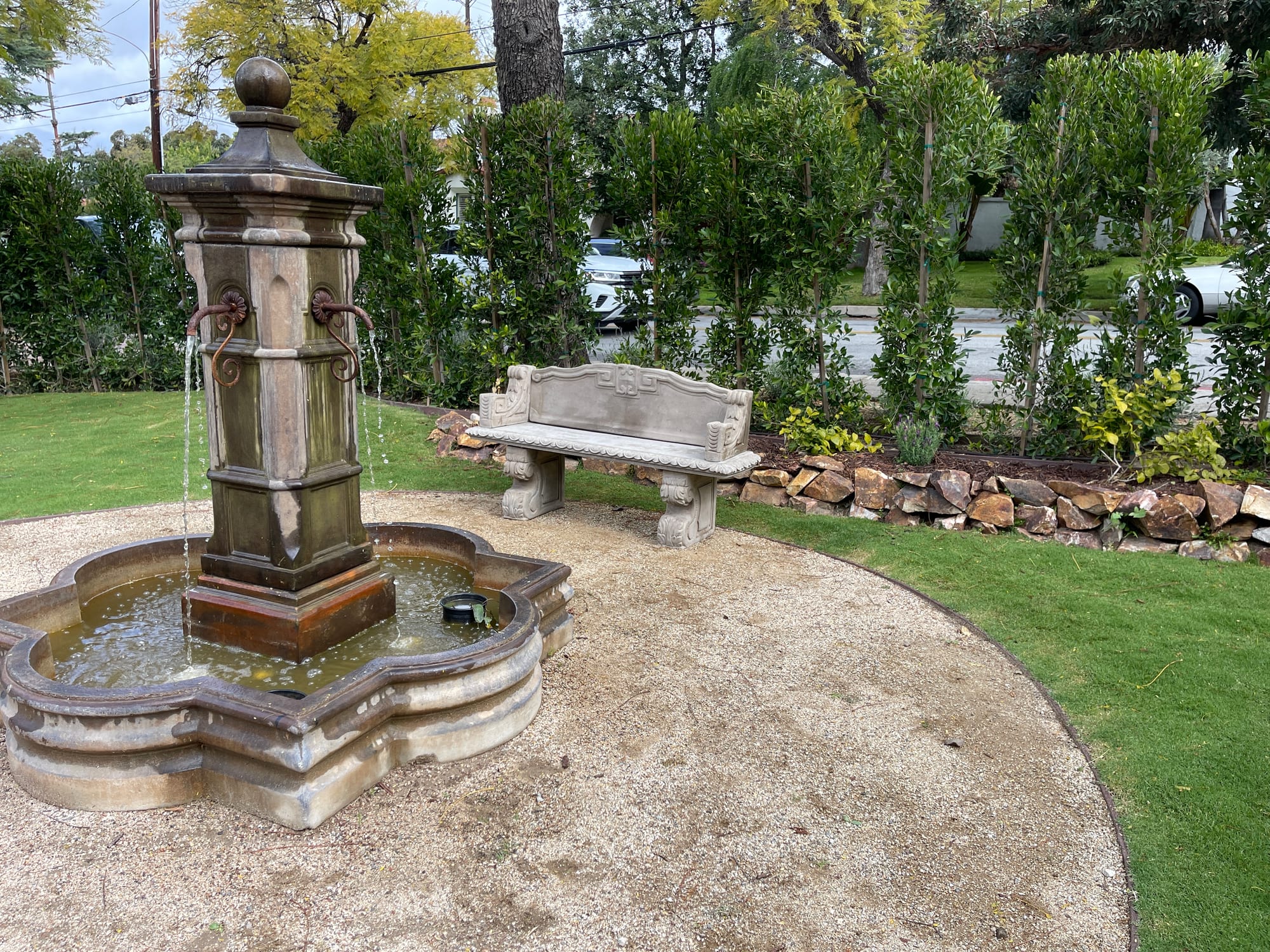 Circular fountain and garden bench on the grounds
