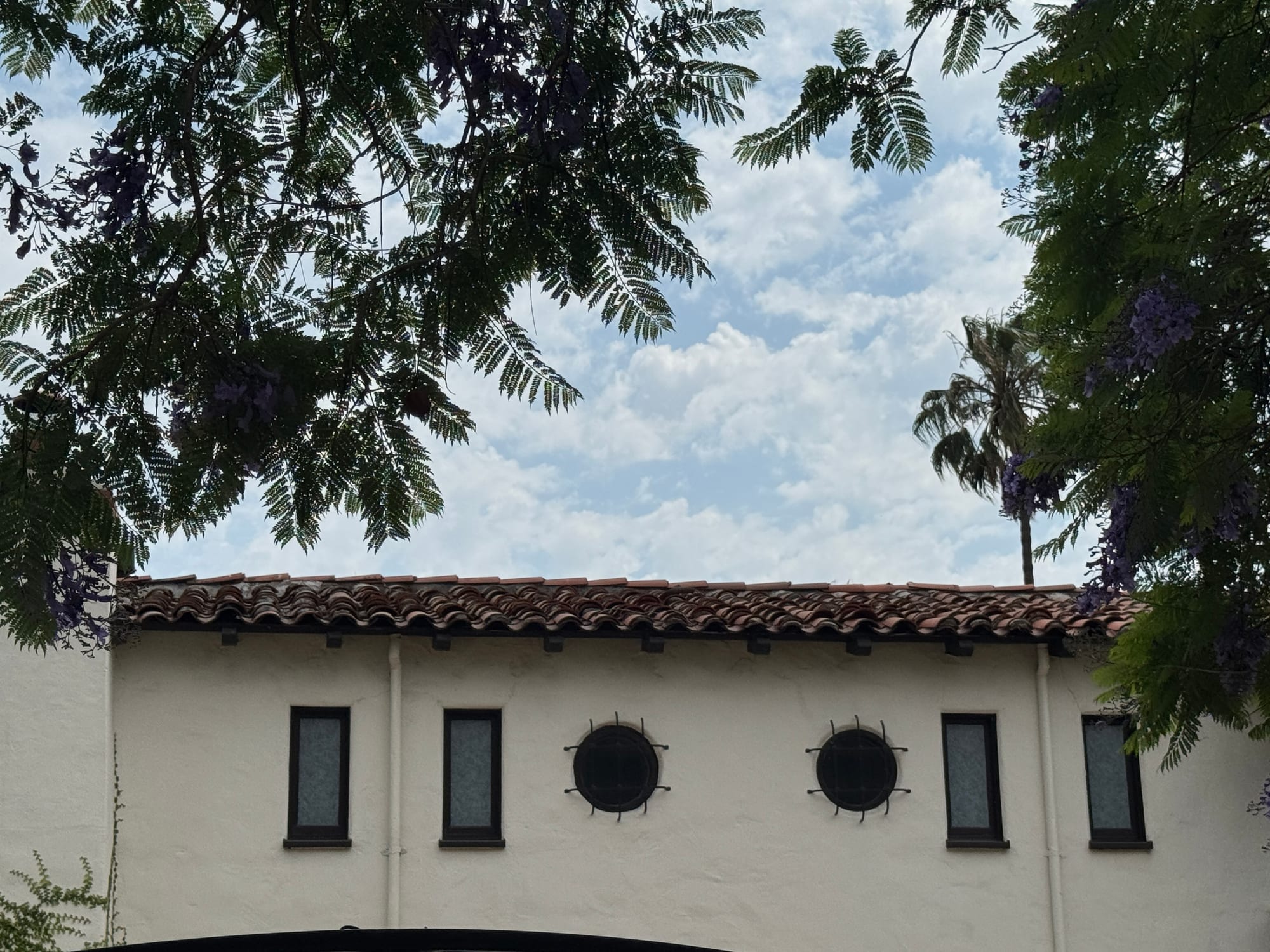 Spanish Colonial architectural detail with round windows and tile roof