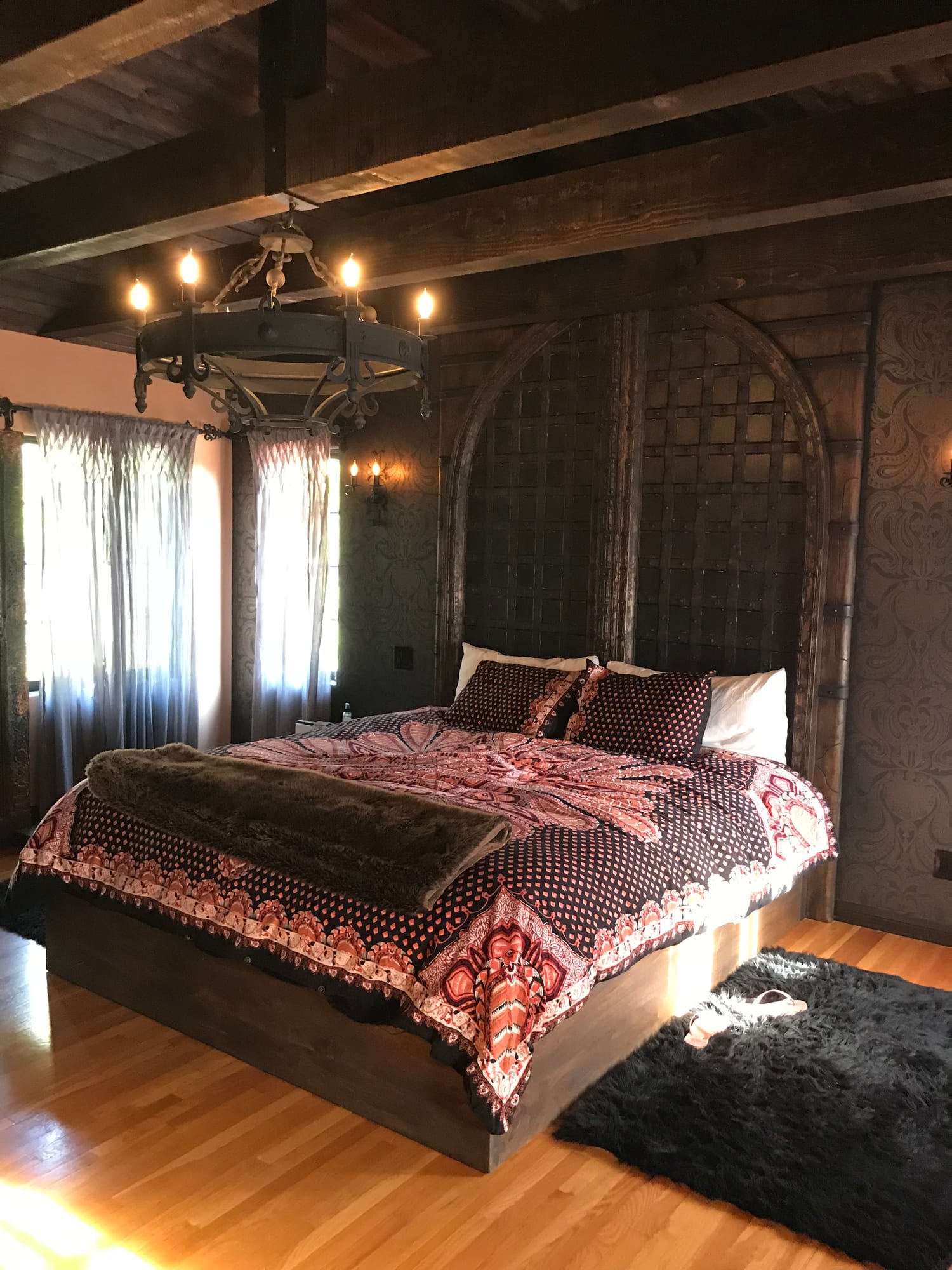 Bedroom with a beamed ceiling and warm lighting
