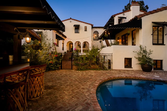 Poolside bar and terrace beside the house at dusk