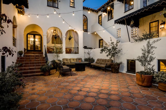 Tiled courtyard with lounge seating and string lights