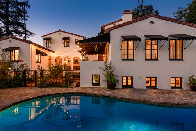 Swimming pool and illuminated house at twilight