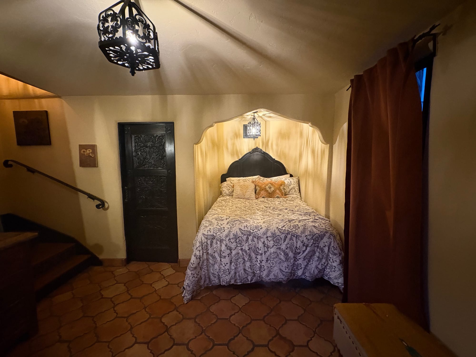 Bedroom with an arched doorway and tiled floor