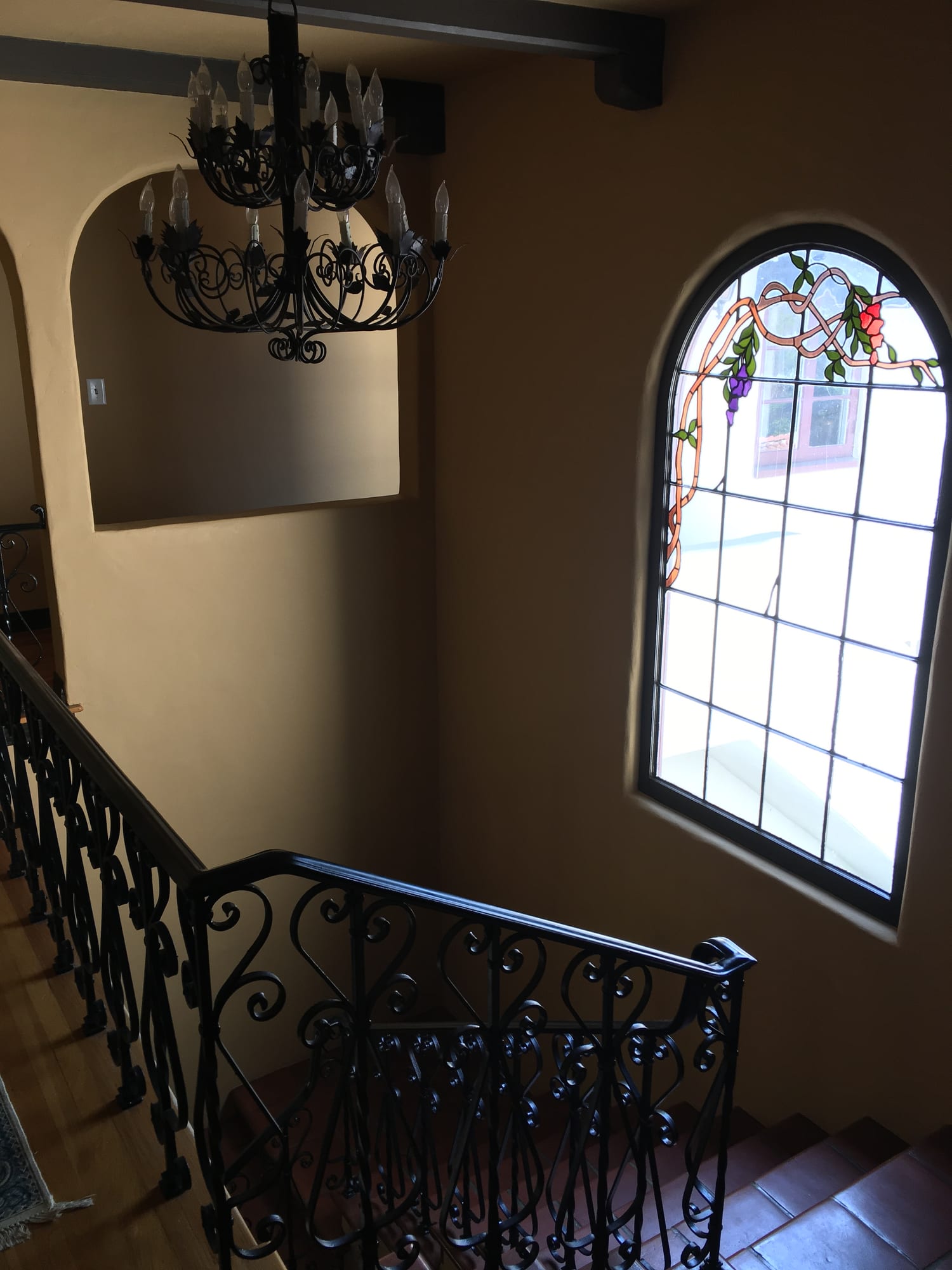 Arched leaded-glass window above the staircase